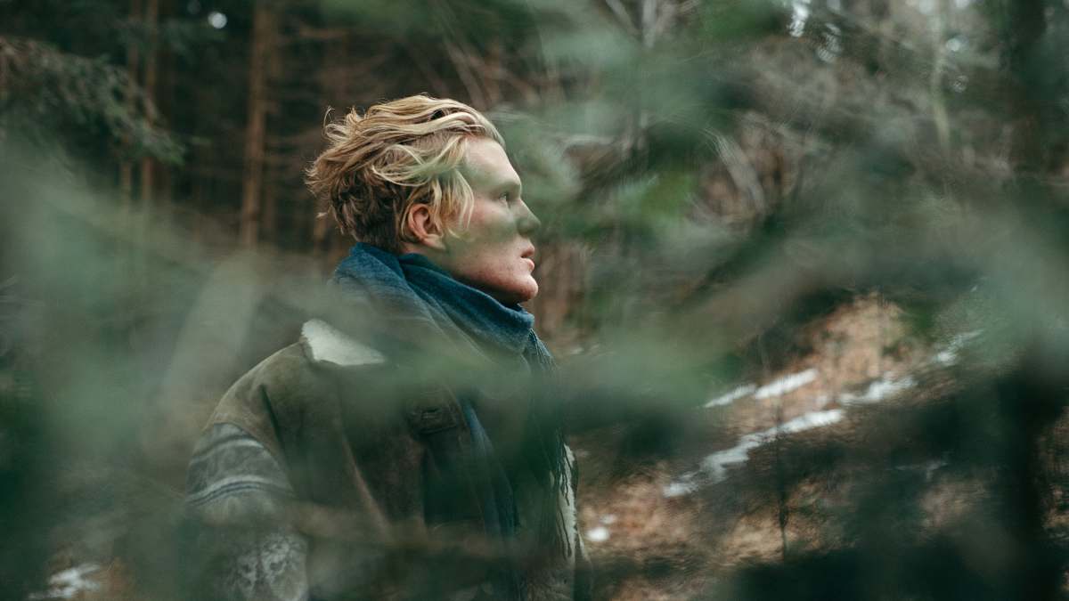 human man wearing blue scarf during daytime blonde