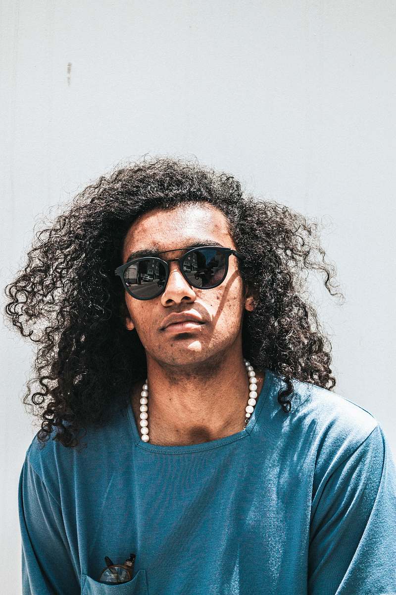 person man wearing blue shirt and black lens sunglasses human