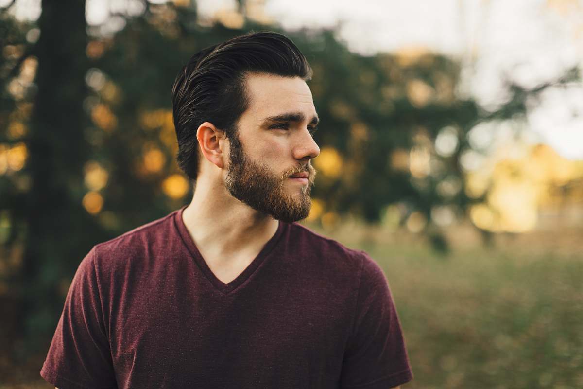 person man wearing maroon V-neck t-shirt in forest human