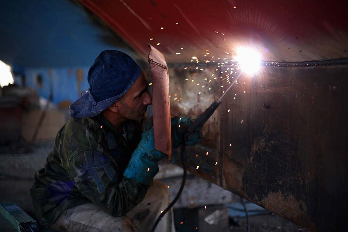 person man welding the brown metal board human