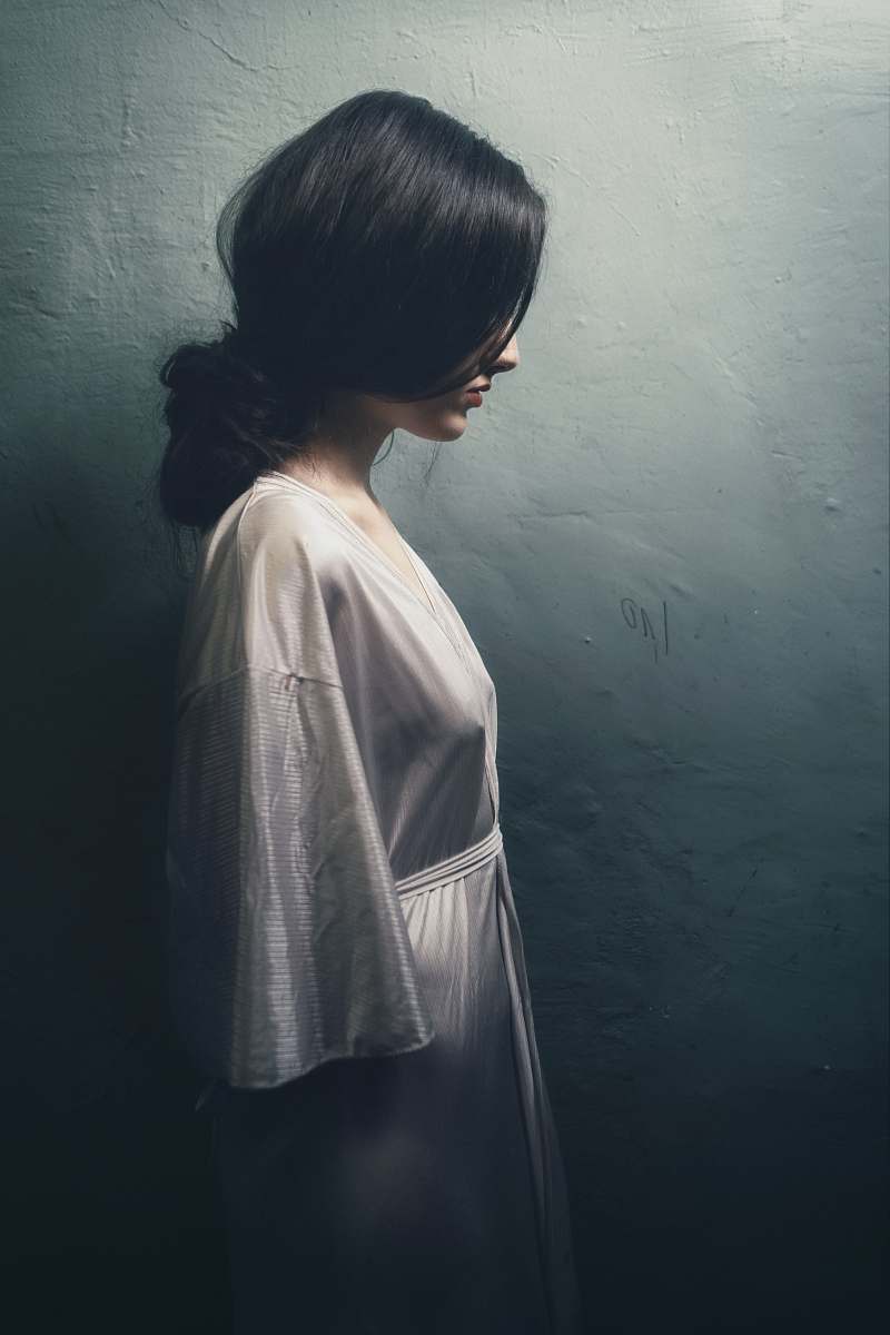 grey painting of woman in white long-sleeved dress woman