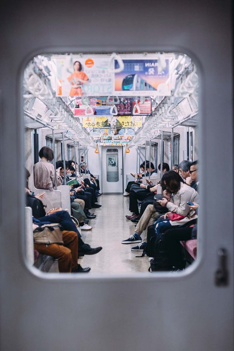 person people at the train looking at their phones japan