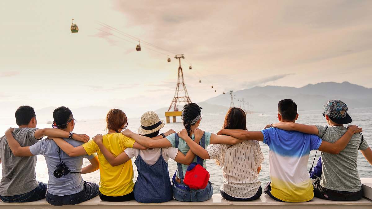 human people holding shoulders sitting on wall person