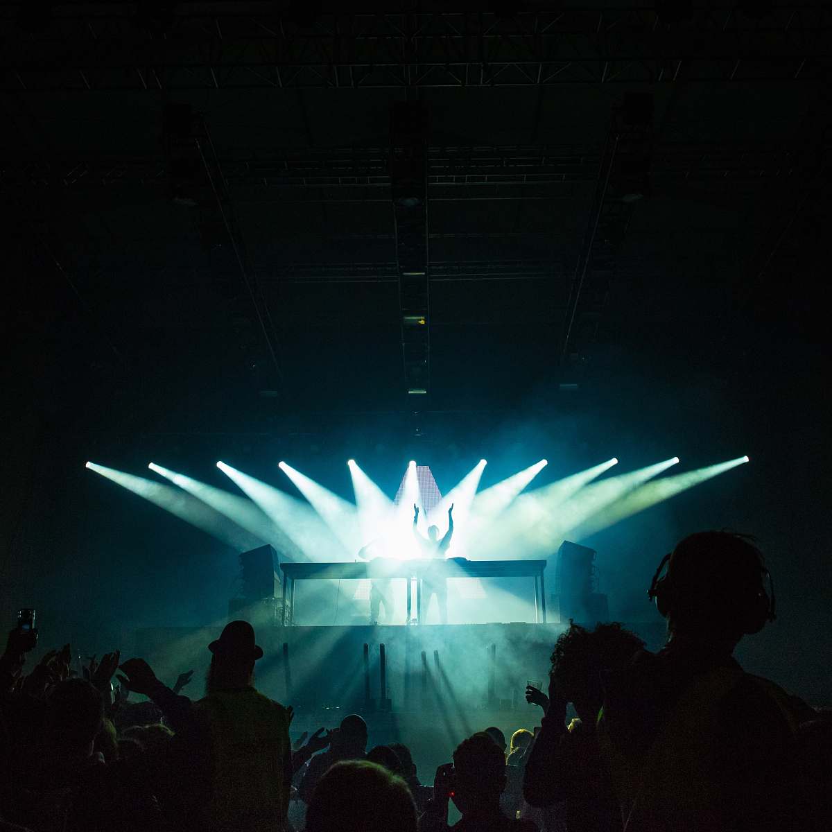 person person standing under stage lights facing crowd human