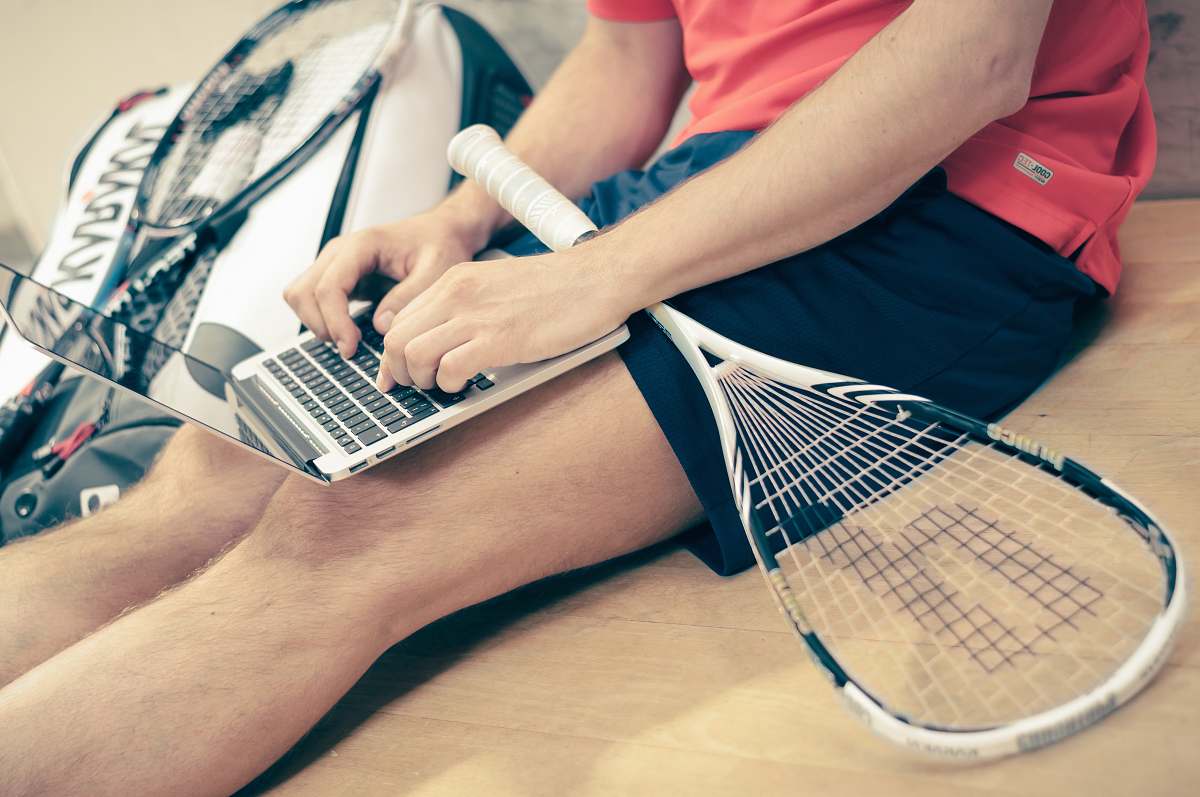 person person wearing black shorts using laptop human