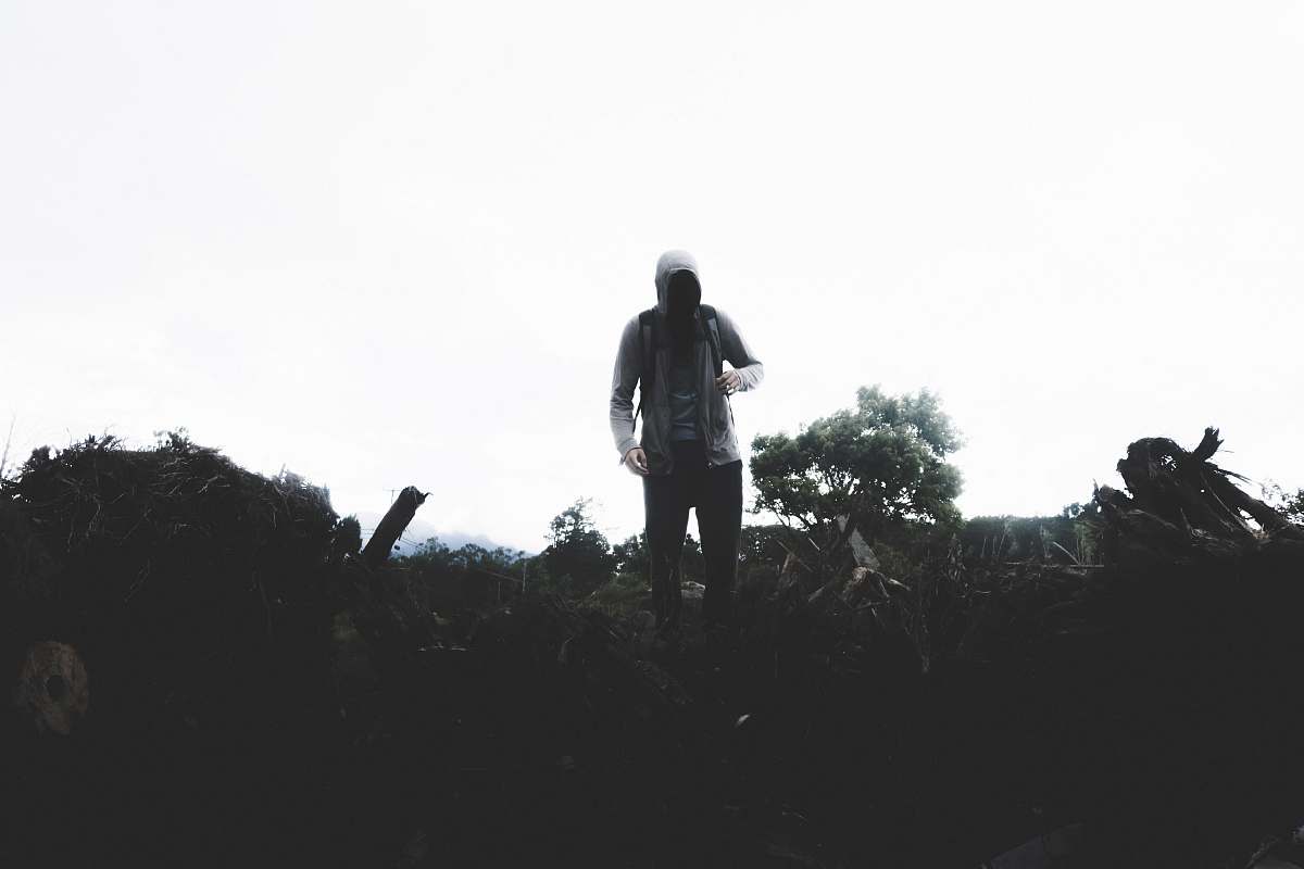 person person wearing hoodie standing on field black-and-white