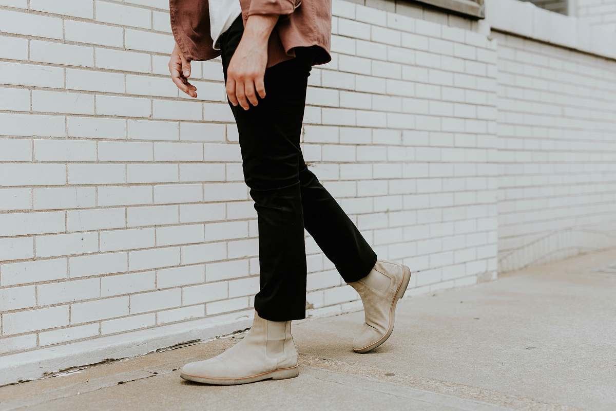 person person wearing white leather chelsea booties and black pants human