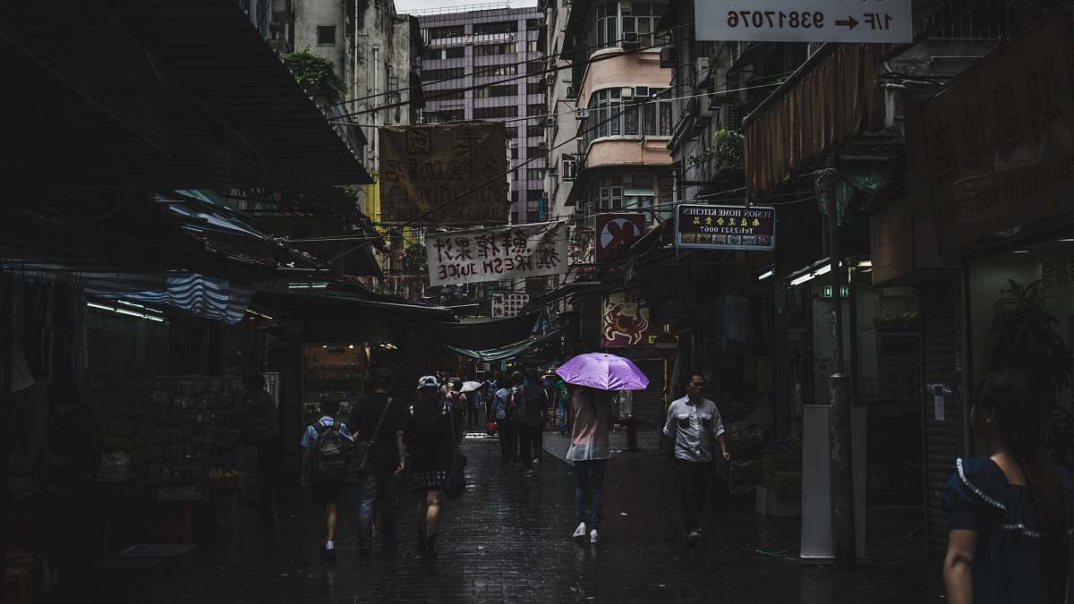 umbrella photography of people walk during rain building