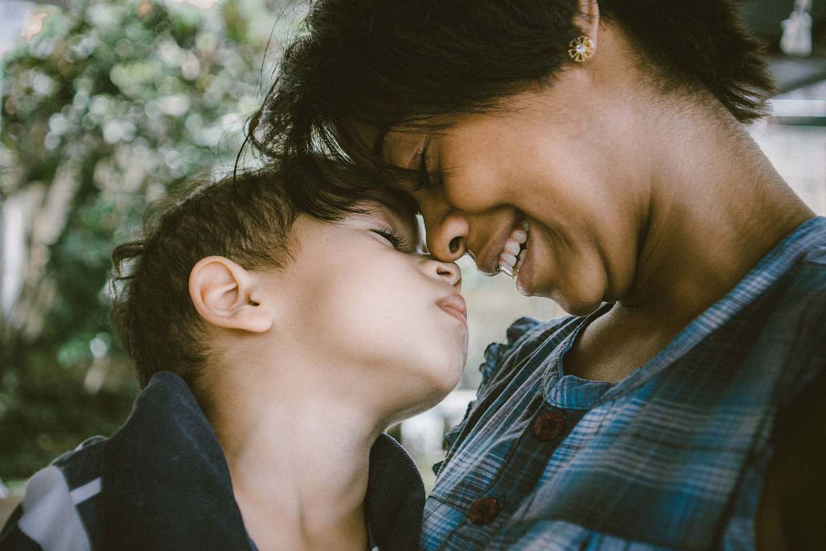 person selective focus photography of woman and boy family