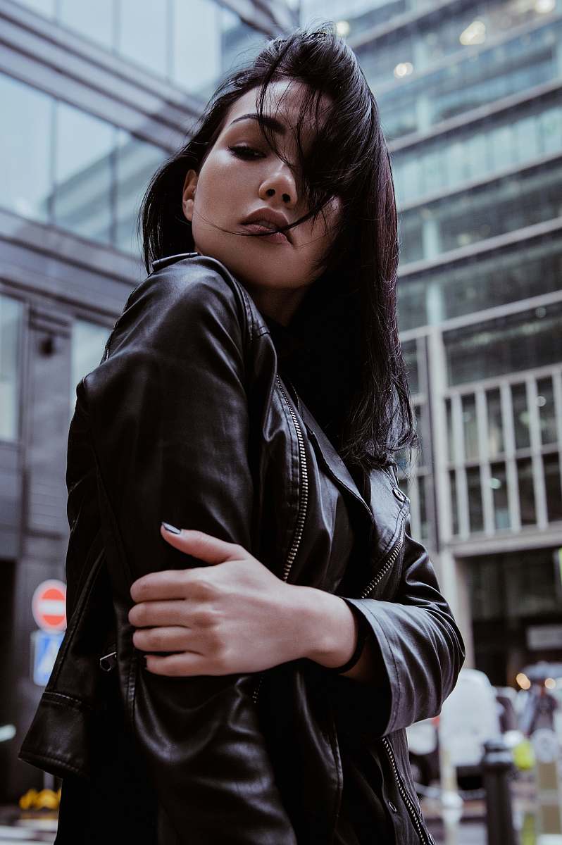person selective focus photography of woman wearing black leather zip-up jacket human