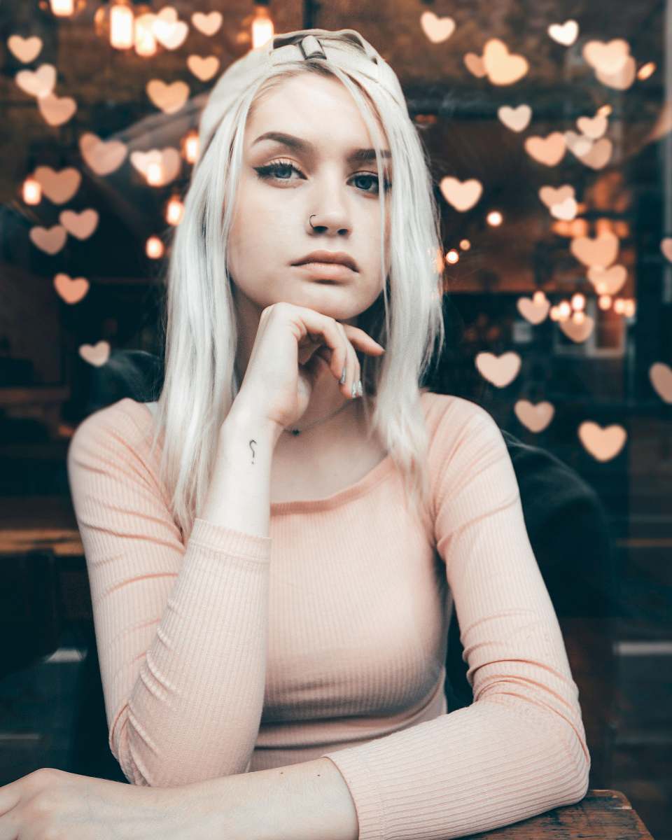 person shallow focus photo of woman sitting on chair human