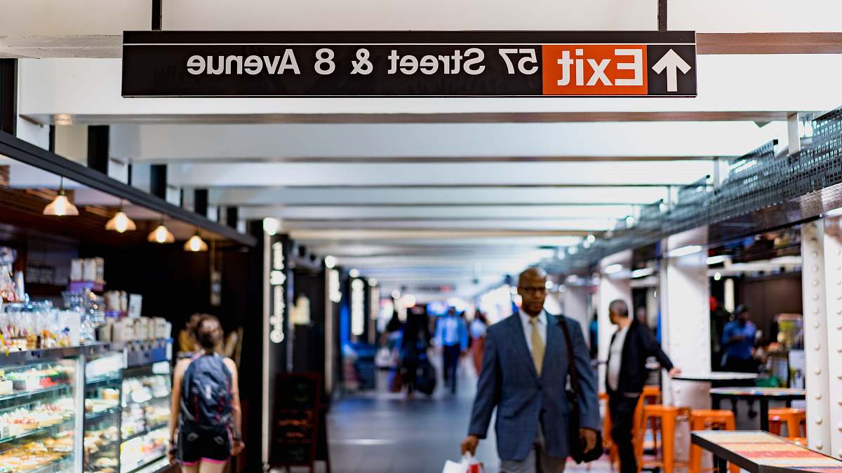 person shallow focus photography of man walking under 57 Street & 8 Avenue tunnel human