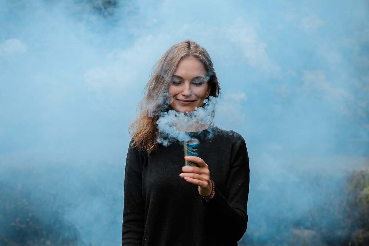 person shallow focus photography of woman surrounded by smoke woman