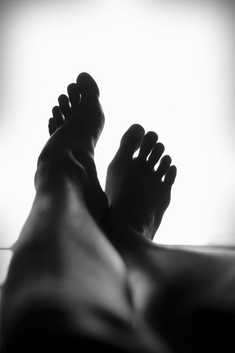 black-and-white silhouette of person's feet against white background legs