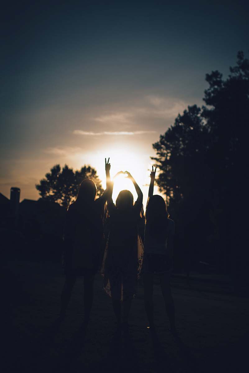 person silhouette of three women during daytime girls