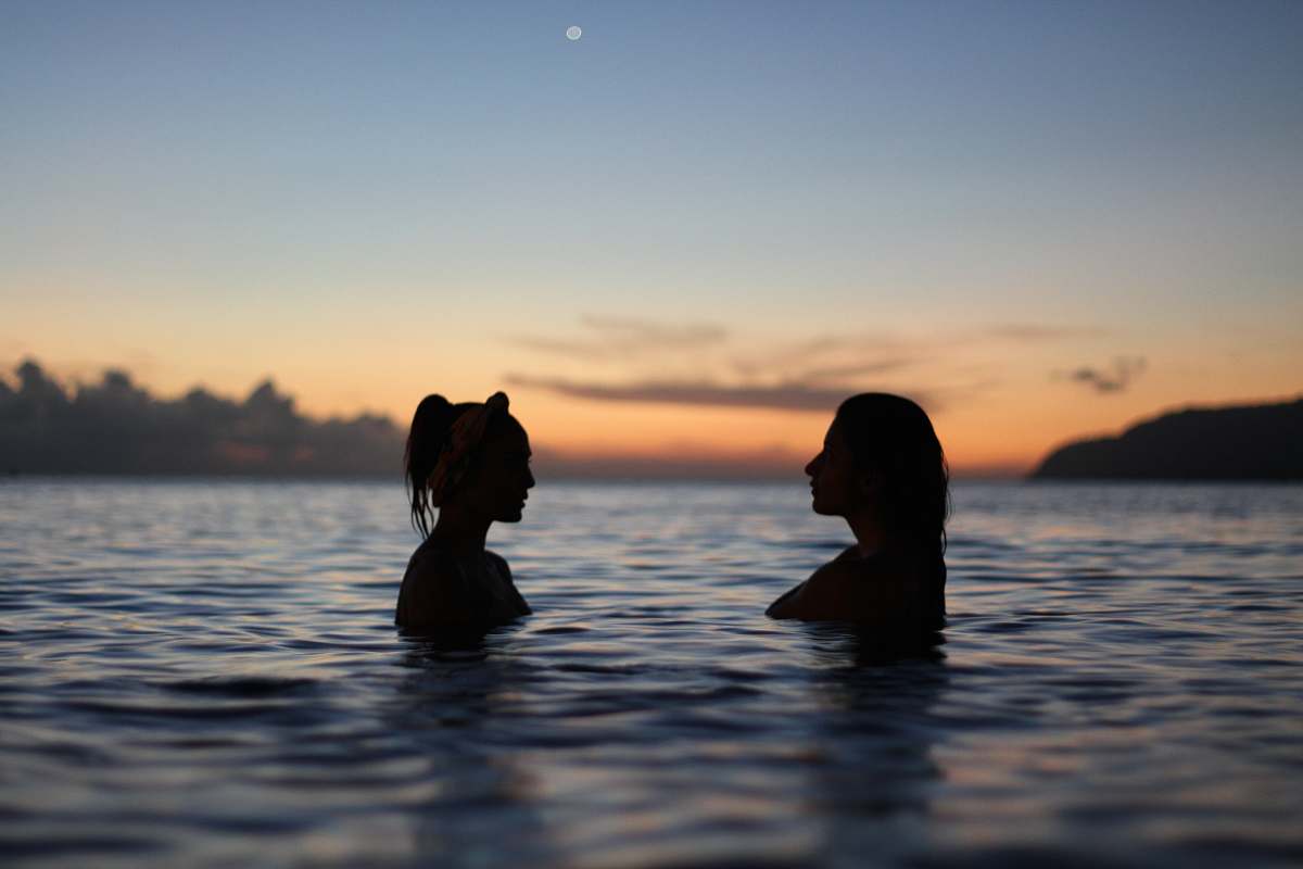 silhouette silhouette of two woman face to face in body water sea