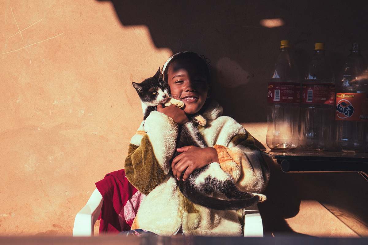 campinas smiling girl hugging cat leaning on wall brazil