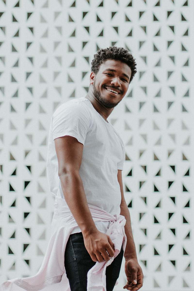 human smiling man wearing white shirt and black jeans person