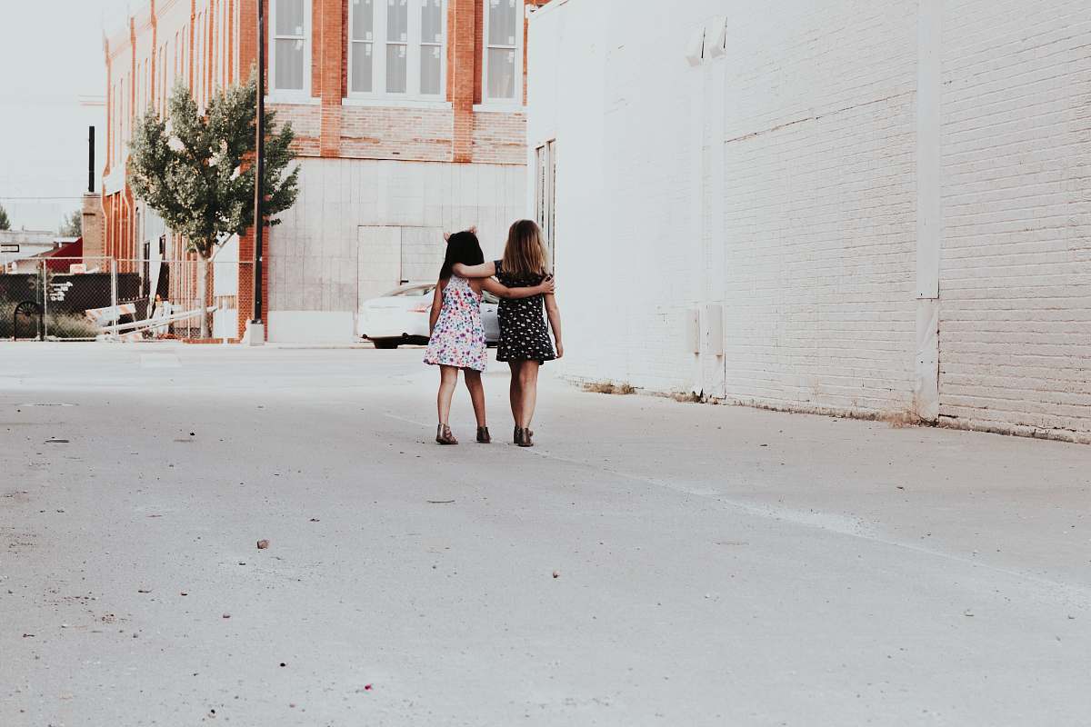 person two girls walking on street human