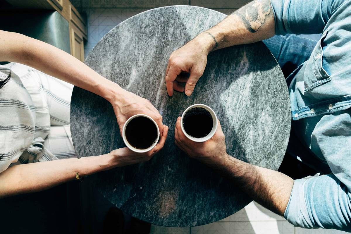 coffee two man and woman holding cups on tables couple