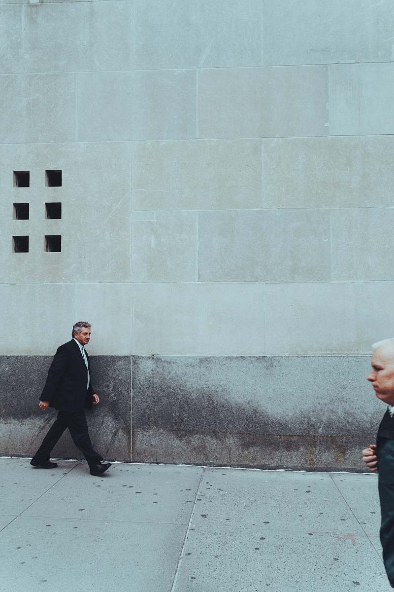 person two man walking near building suit
