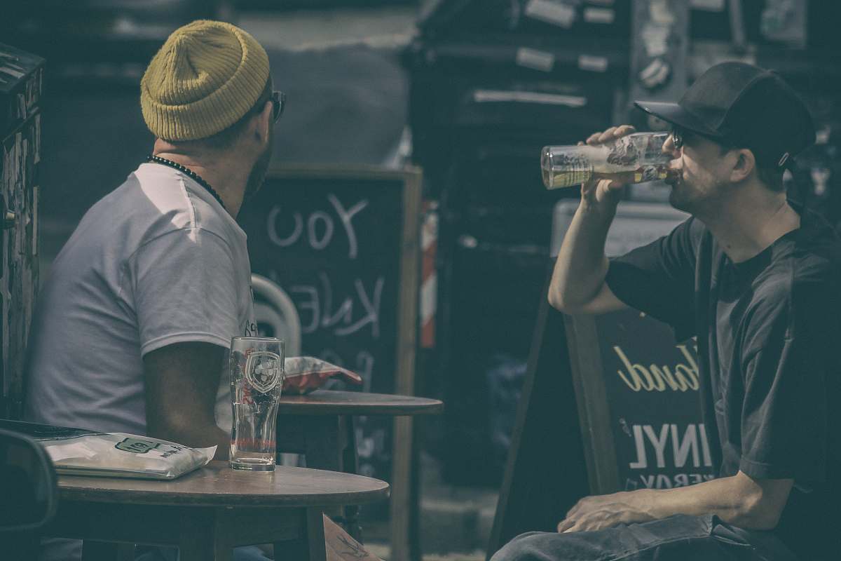 person two men drinking beers human