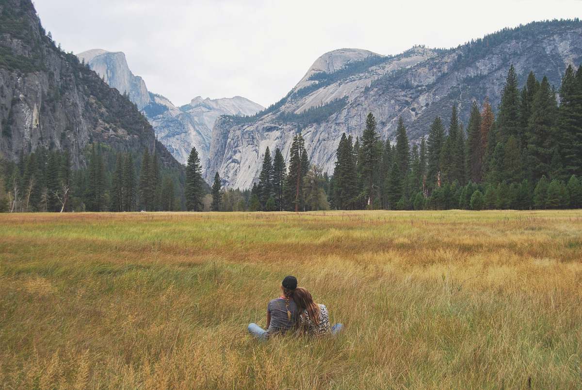 couple two person sitting on grass field field