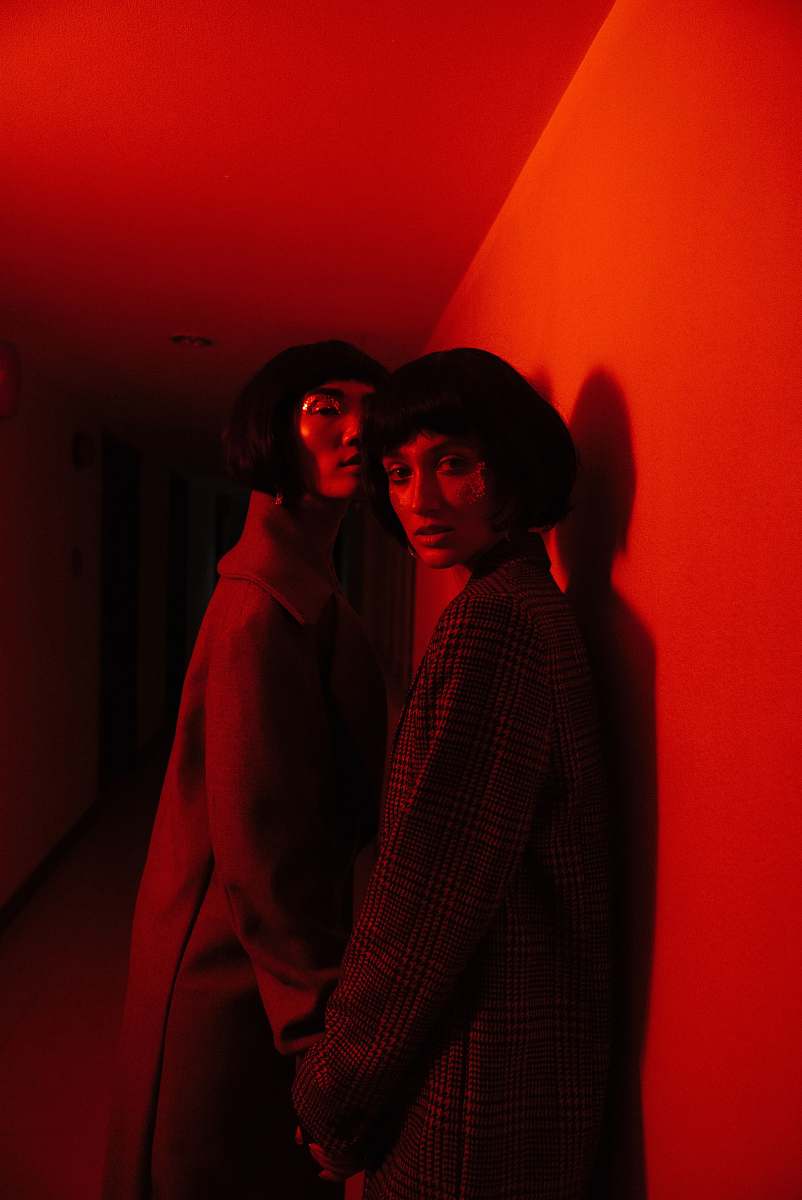 person two woman wearing coat standing near wall human