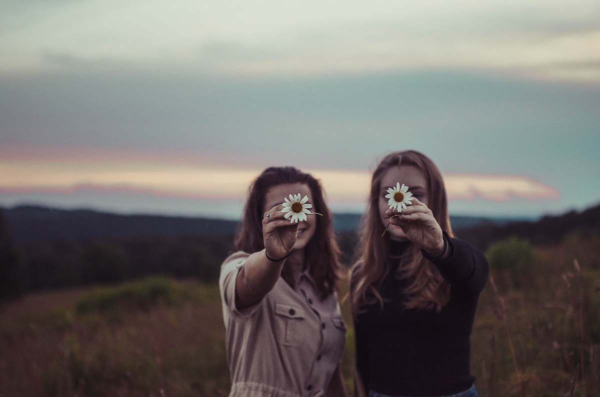 person two women holding flowers human