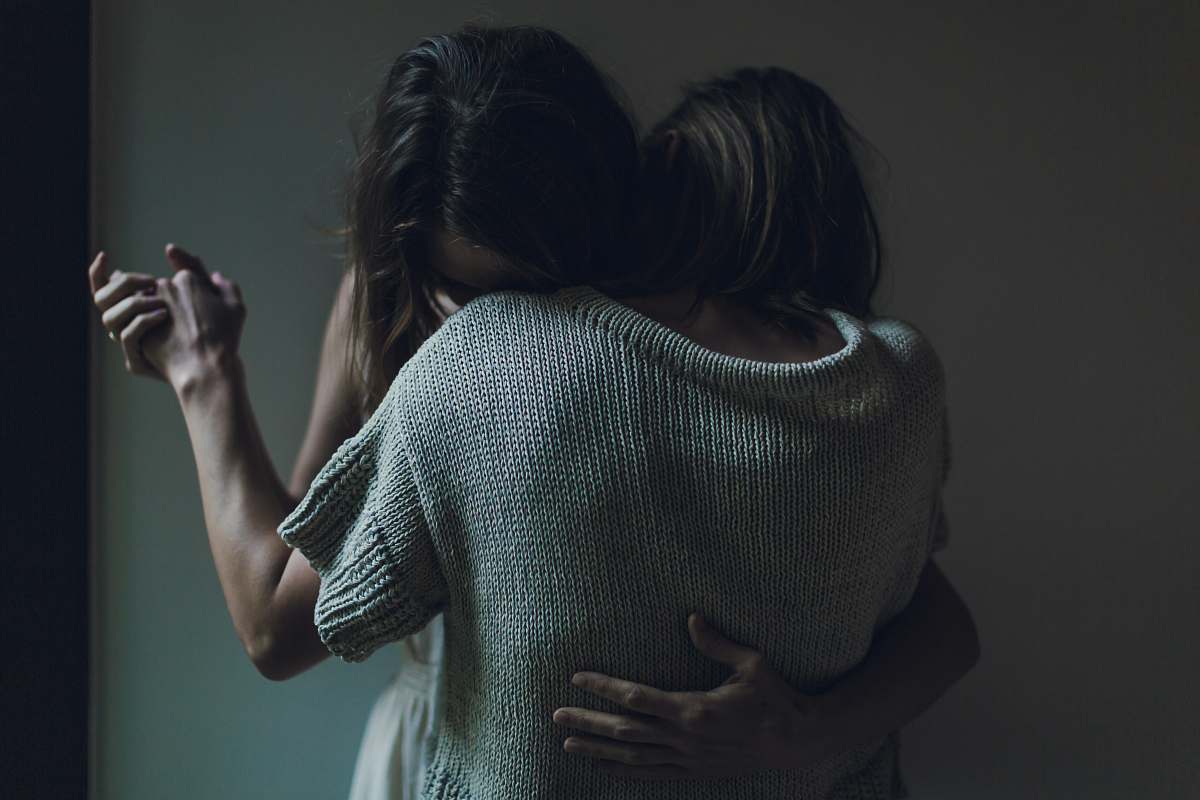 human two women hugging each other woman