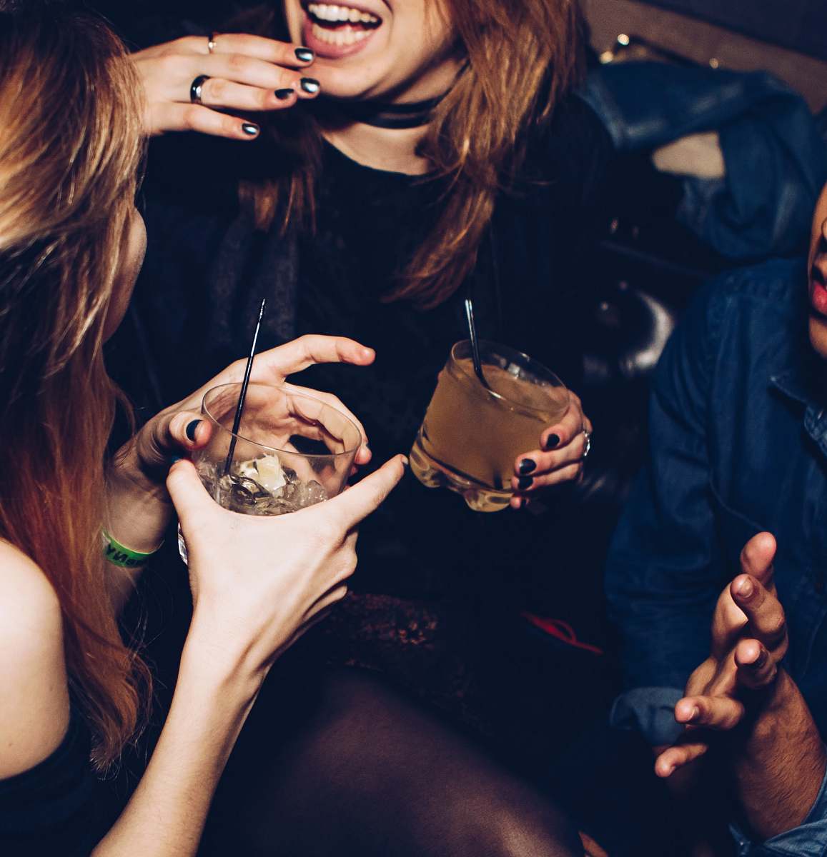 Capture the lively essence of nightlife with this stunning image of two women engaged in animated conversation while holding their drinks in a bustling nightclub. Perfect for illustrating themes of friendship, celebration, or nightlife culture, this photograph encapsulates the joy and excitement of social gatherings. Ideal for use in event promotion, social media content, or articles about nightlife and friendship.