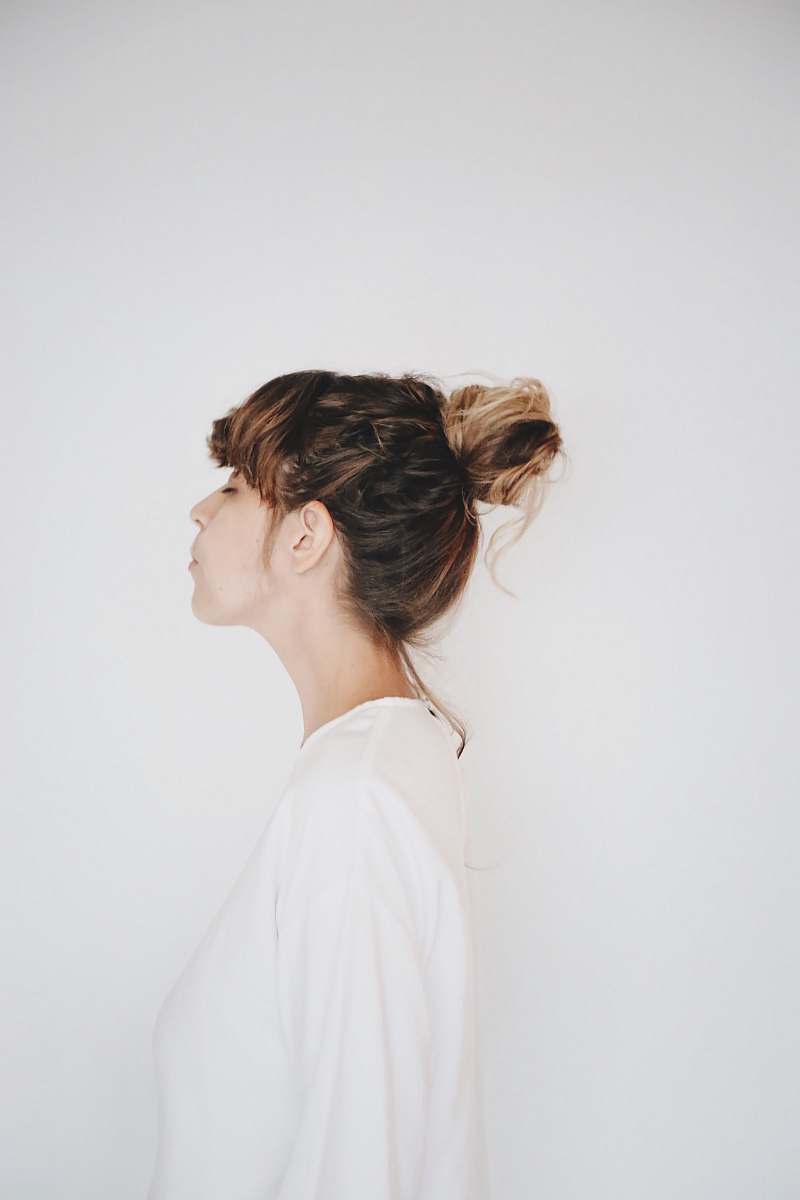 human woman beside white wall person
