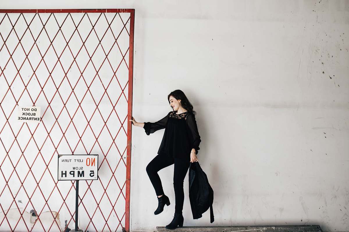 woman woman carrying black bag white wall