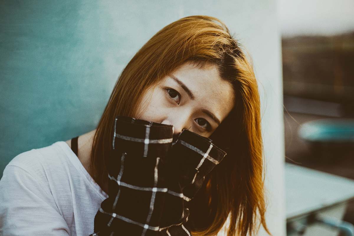 person woman hiding her mouth with her hands human