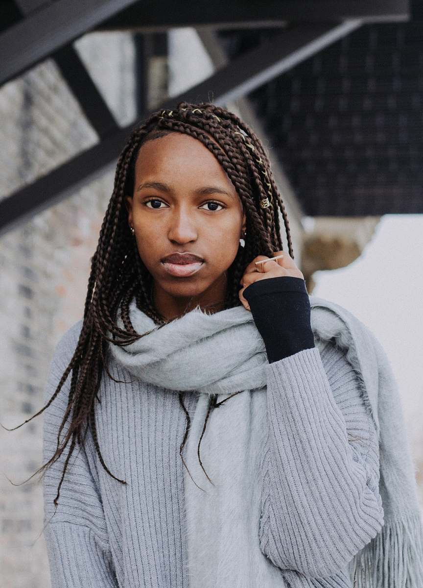 woman woman holding her braided hair person