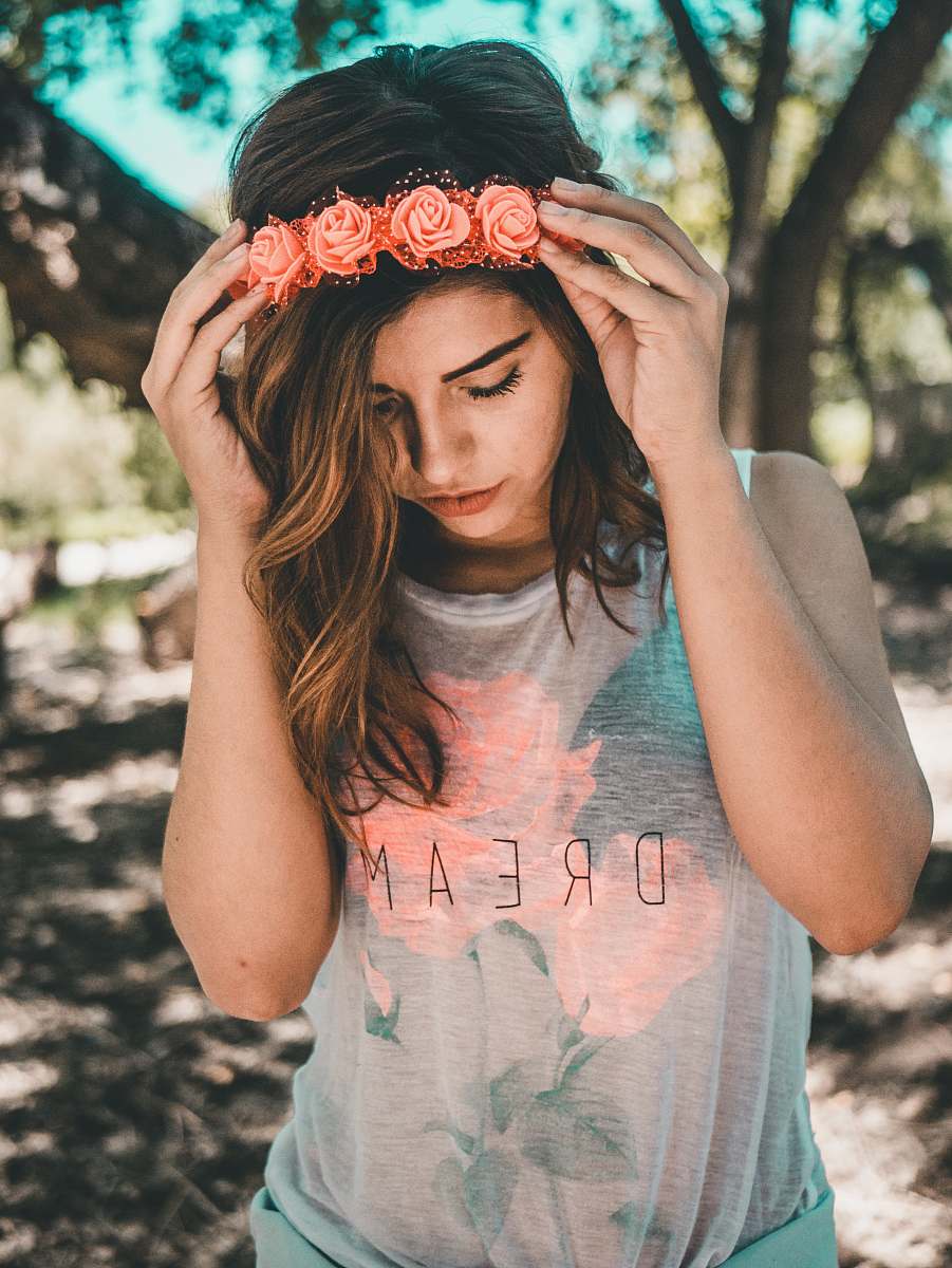 person woman in gray and pink floral sleeveless top during daytime human