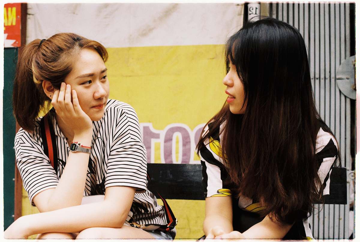 person woman in white-and-black striped tops looking each other human