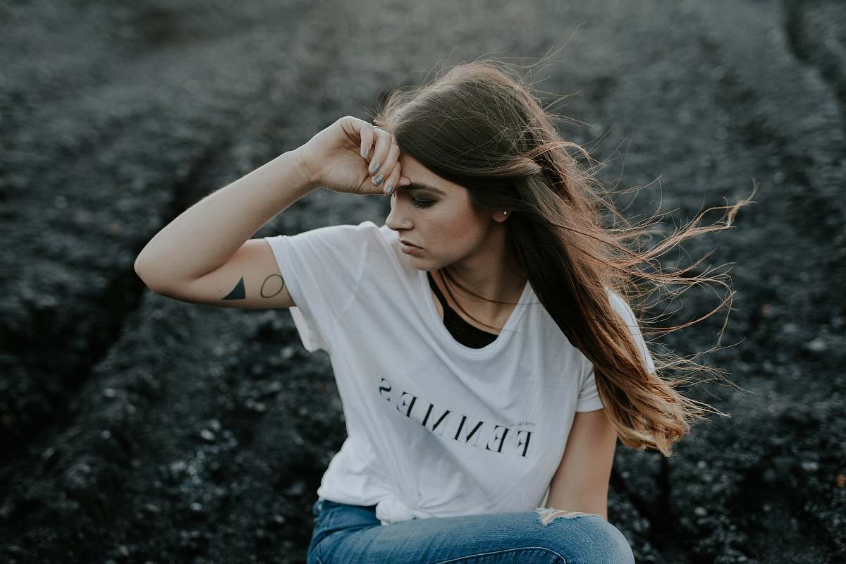 person woman in white shirt sitting on ground girl