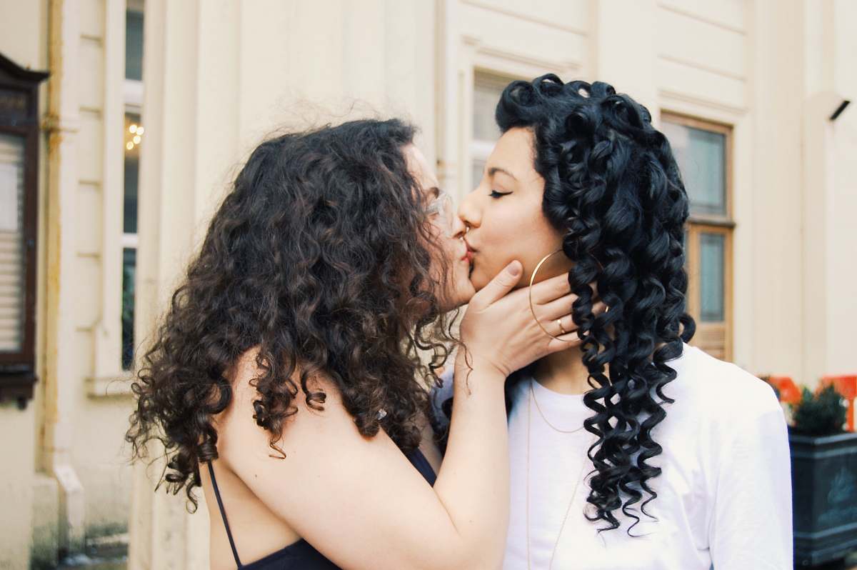 human woman kissing another woman person