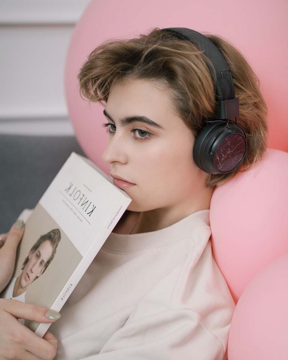 person woman listening on black headphones human