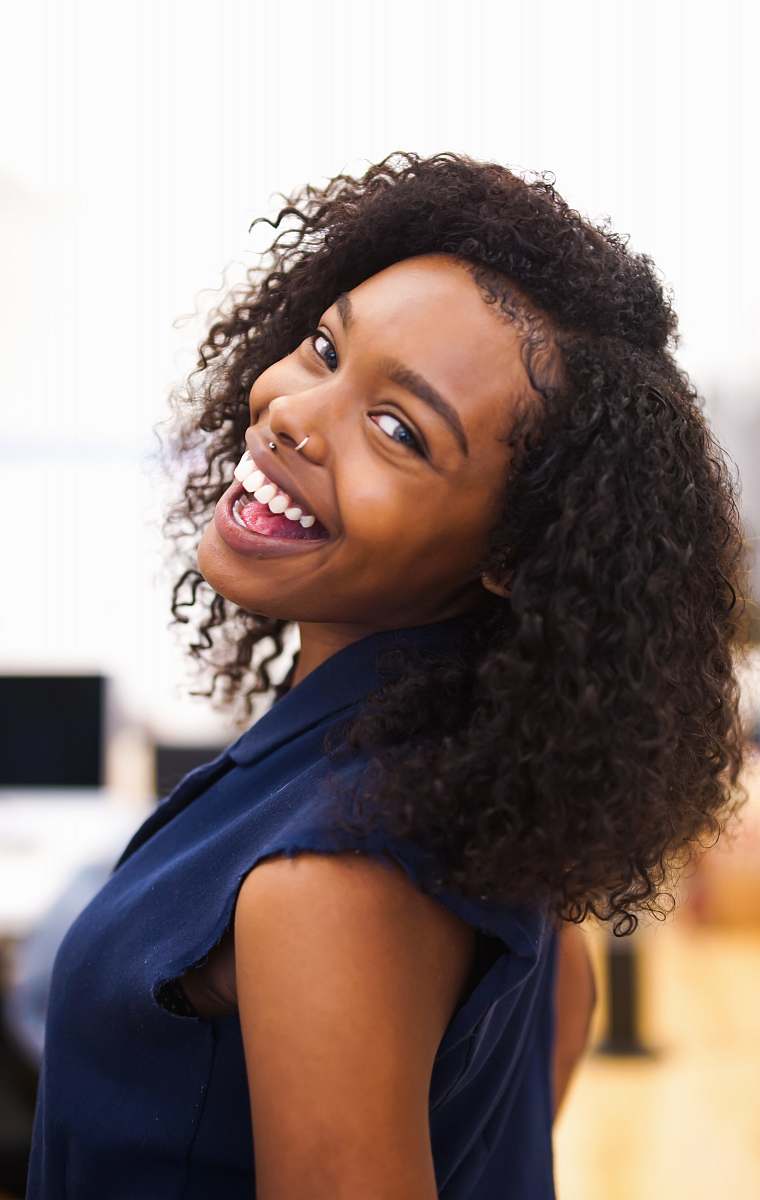 human woman looking back while smiling woman
