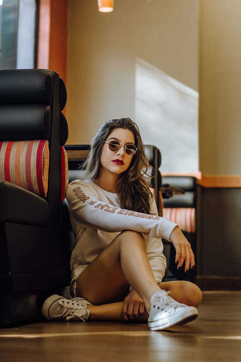 person woman sitting near sofa with cross legs human