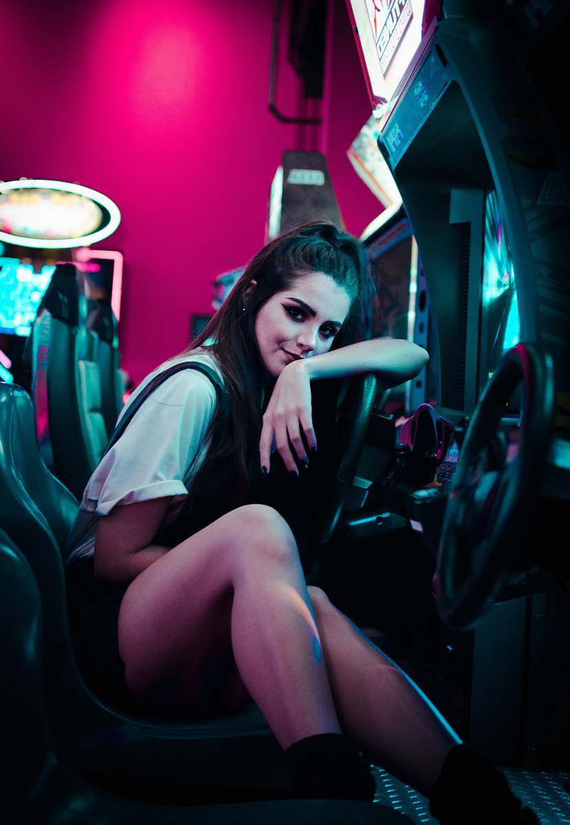 person woman sitting on car arcade machine human