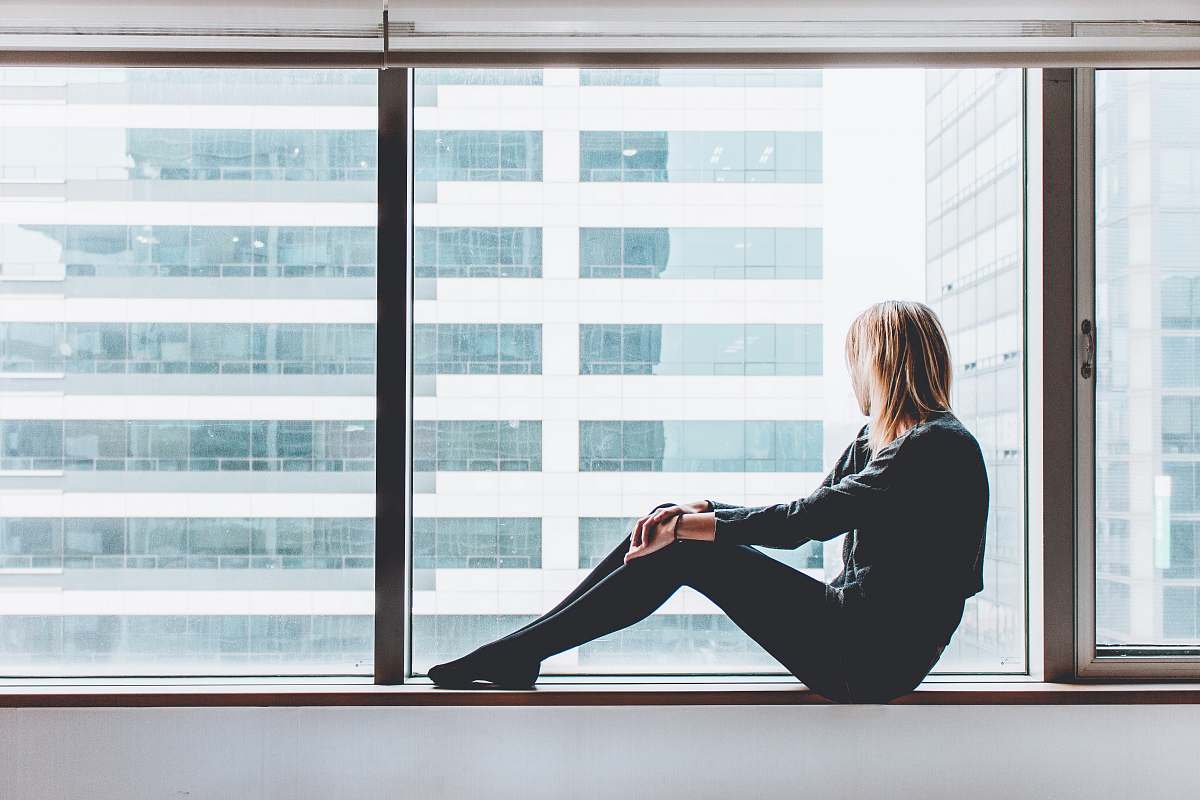 woman woman sitting on window window