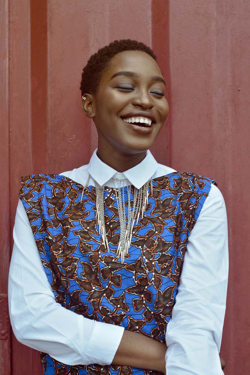 person woman smiling beside red wall human