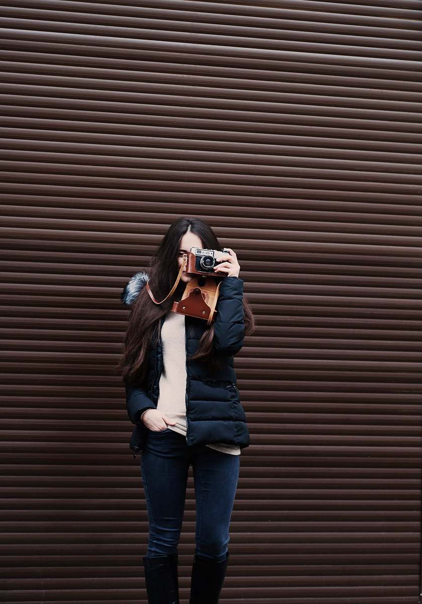 person woman standing holding camera taking photo human
