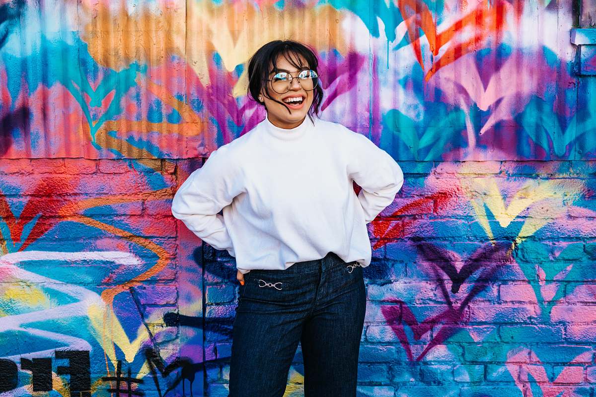 person woman standing in front of multicolored wall human