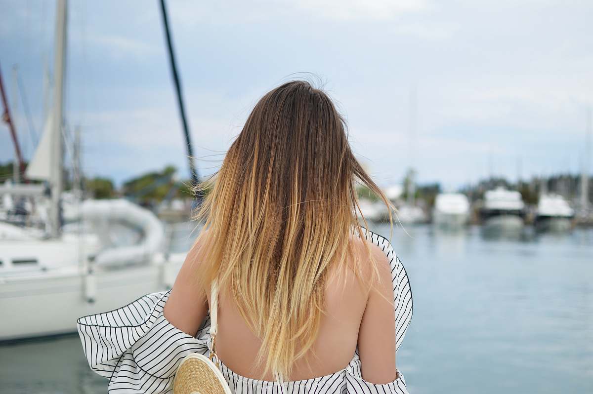 human woman standing in front of white yacht girl