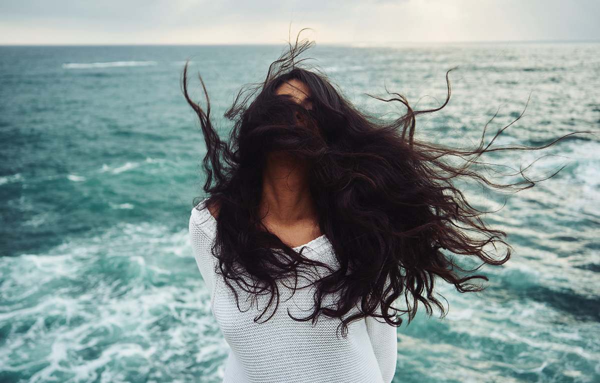 person woman standing near body of water during daytime woman