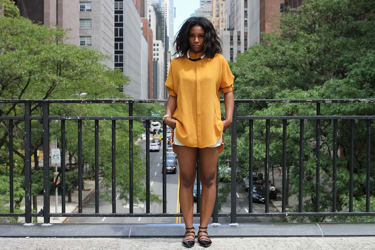 person woman standing on brown bridge during daytime woman